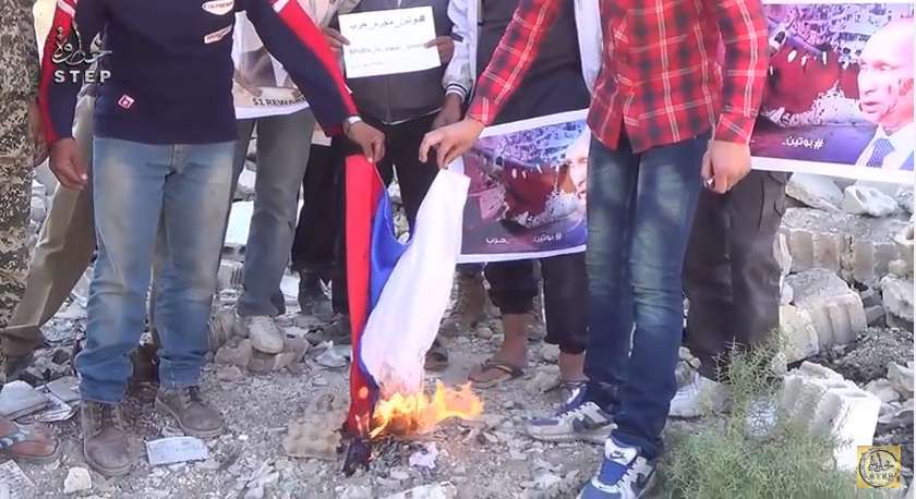 "Путин убивает наших детей, он военный преступник": мирные сирийцы сожгли российский флаг на руинах жилых кварталов (кадры)